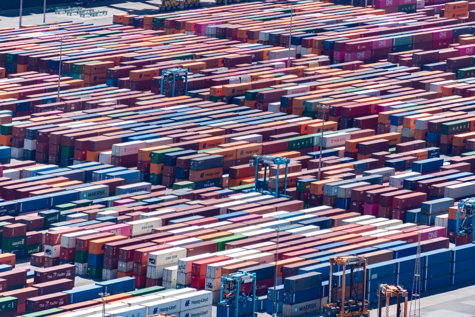 Aerial view of colourful shipping containers stacked at a busy port