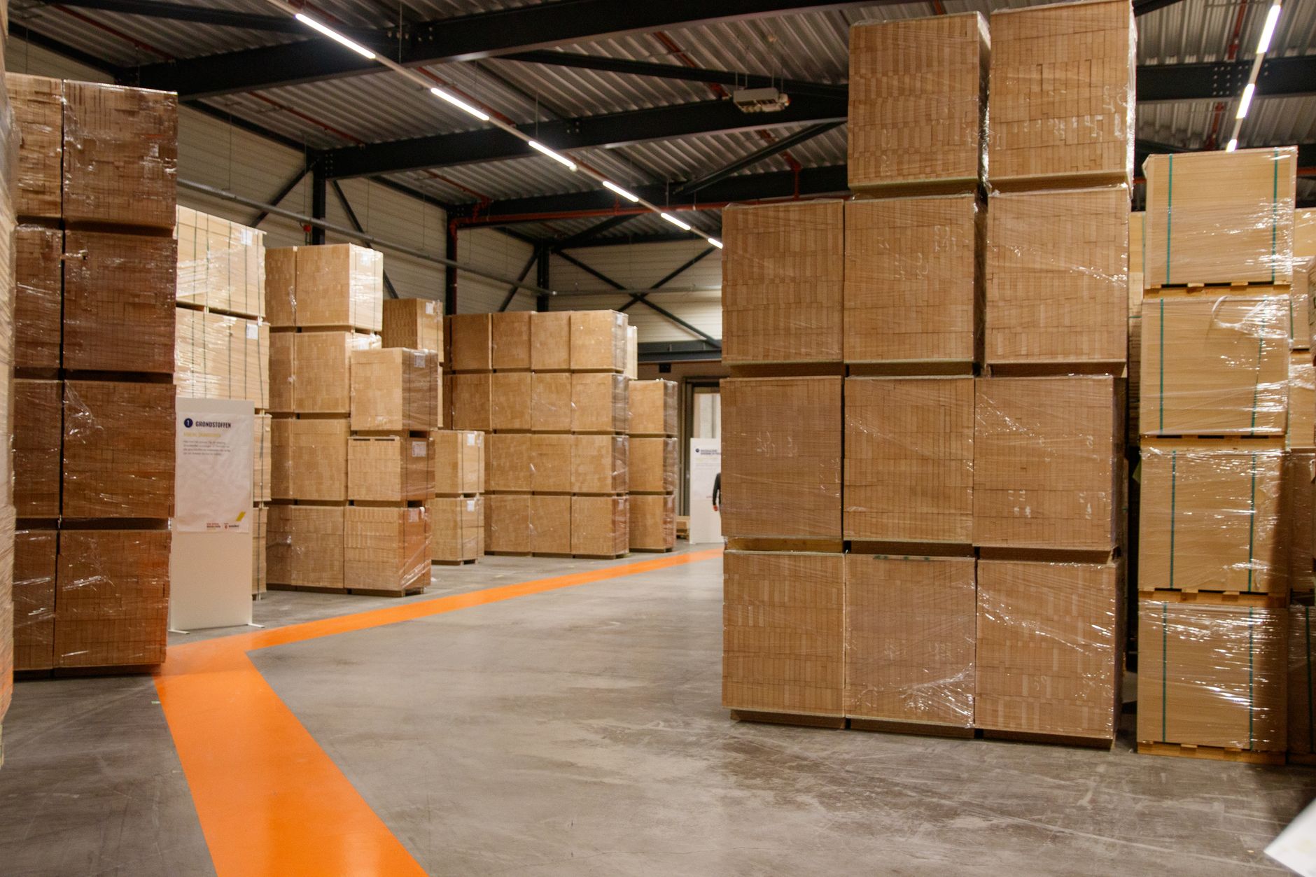 One consolidated load: cartons from several suppliers palletised and shrink-wrapped for a single outbound shipment.